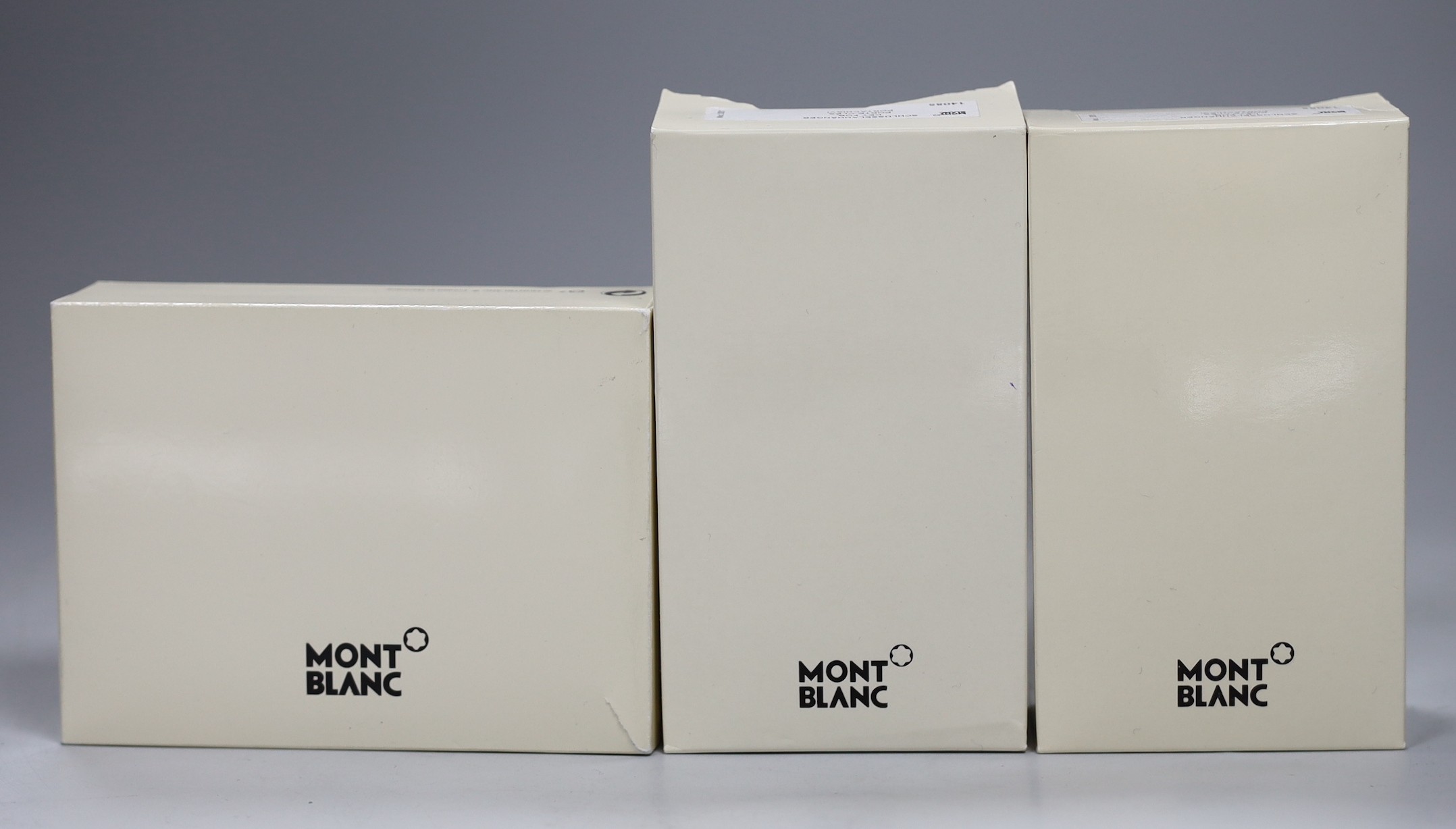 A Mont Blanc Meisterstuck credit card holder (new), a Mont Blanc Porte Cles key fob (new, full certification) and a Mont Blanc Porte Cles key fob (new, fill certification)